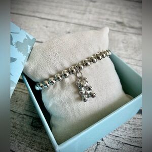 NEW! In box. Gorgeous stretchy beaded bracelet w/ teddy bear charm, silver tone